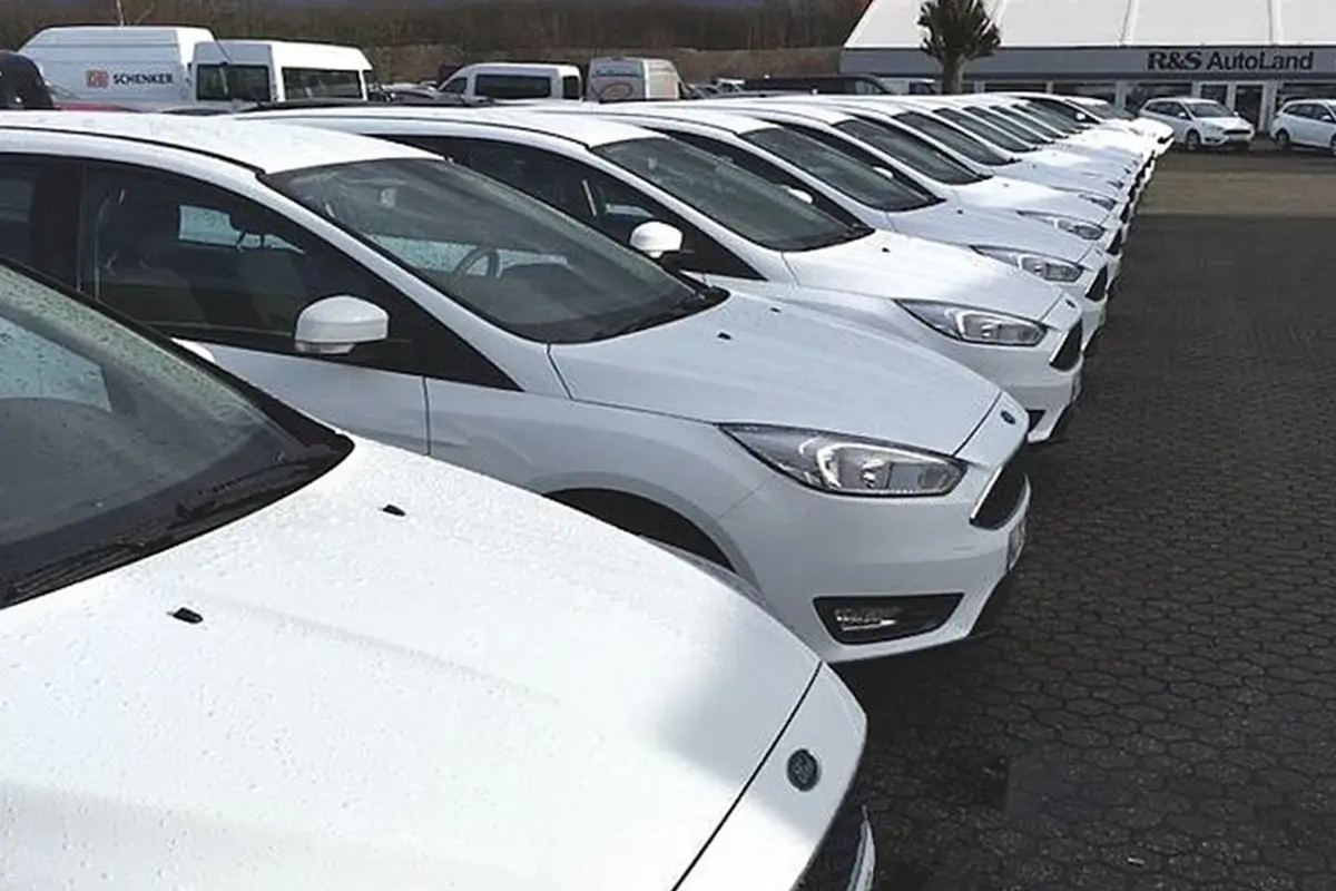 Ein Autohof auf dem viele weiße Ford Fahrzeuge zu sehen sind